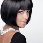 Fashion Haircut. Hairstyle. Sexy Lady. Stylish Fringe. Short Hair Style. Brunette woman with jewelry pearls