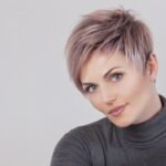 Portrait of a beautiful blonde woman with beautiful make-up and short haircut after dyeing hair in a hairdressing salon.
